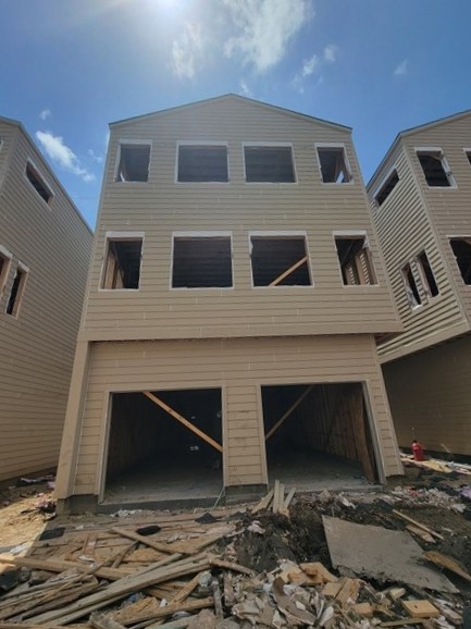 Exterior progress on a multi-story residential construction project